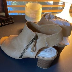 Super cute open toe booties. New, never worn. There is one spot that has a mark.